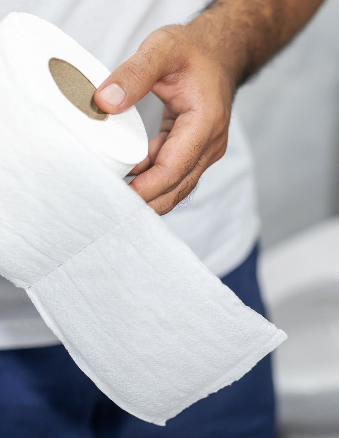 A man holding toilet paper A man holding a toilet paper roll unravelling.